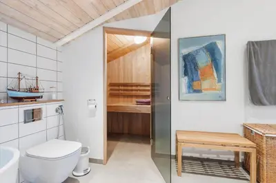a bathroom with a toilet and a bath tub at BL1141-Saltum-Faarup-Klitvej-2-A in Saltum
