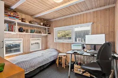 a bedroom with a bed and a desk with a computer at BL1141-Saltum-Faarup-Klitvej-2-A in Saltum