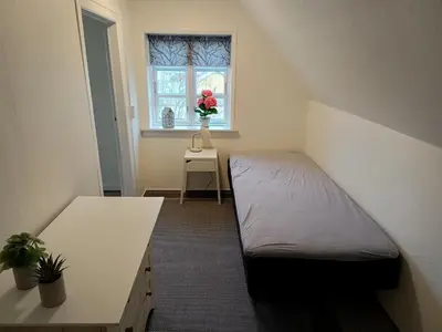 a small room with a bed and a window at Bolig ved hav og fjord in Thyholm