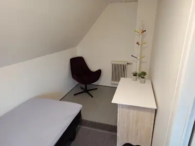a room with a bed and a desk and a chair at Bolig ved hav og fjord in Thyholm
