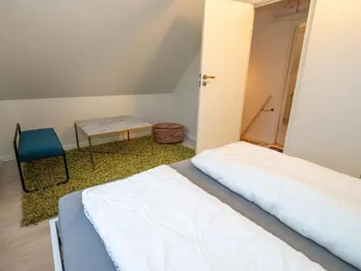 a bedroom with a bed and a table and a chair at 4 person holiday home in Hanstholm in Hanstholm