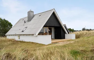 a barn with a metal roof on top of a field at 2 Bedroom Pet Friendly Home In Thisted in Thisted