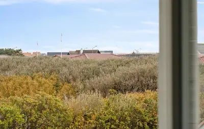 a view from a window of a field of grass and buildings at Nice Home In Thyborøn With Wifi in Thyborøn