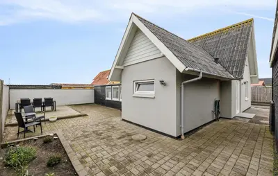 a small white house with a pitched roof at Nice Home In Thyborøn With Wifi in Thyborøn