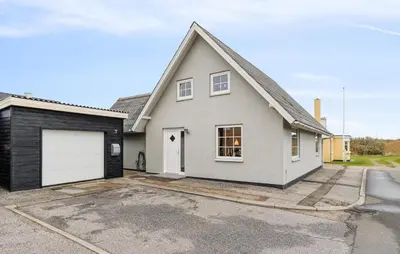 a white house with a garage at Nice Home In Thyborøn With Wifi in Thyborøn
