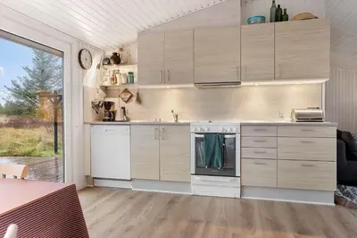 a kitchen with white cabinets and a large window at 741-Thisted-Klemsvej-29 in Nørre Vorupør