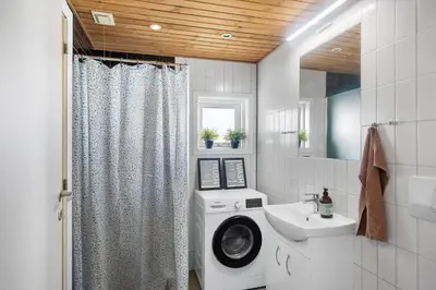 a bathroom with a washing machine and a sink at 822-Harboore-Neerlandiavej-138 in Harboør