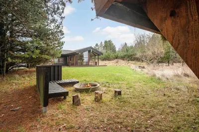a house with a fire pit in the yard at JB372-Fjerritslev-Ronnevej-3