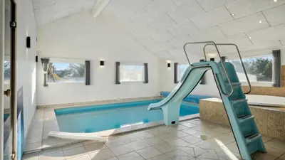 a bathroom with a swimming pool and a slide at Villavilla 176 - Vrist, Vestjylland in Harboør