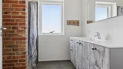 a white bathroom with a sink and a mirror at Villavilla 607 - Vorupør, Nordjylland in Thisted