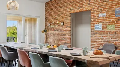 a dining room with a long table and chairs at Villavilla 607 - Vorupør, Nordjylland in Thisted