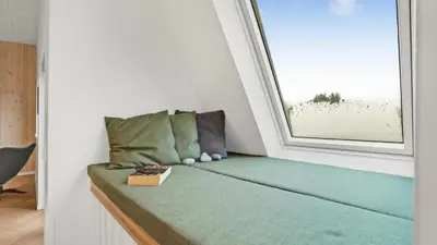a bed in a room with a window at Villavilla 603 - Hostrup Strand, Limfjorden in Spottrup