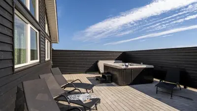 a patio with chairs and a table on a building at Villavilla 547 - Hostrup Strand, Limfjorden in Spottrup