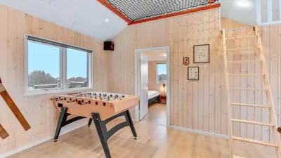 a room with a foosball table in the middle at Villavilla 539 - Hostrup Strand, Limfjorden in Spottrup
