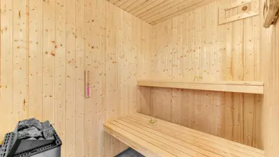 a wooden interior of a sauna with a shelf at Villavilla 539 - Hostrup Strand, Limfjorden in Spottrup