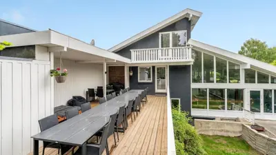 a house with a large deck with chairs at Villavilla 373 - Glyngøre, Limfjorden in Roslev