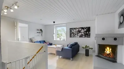 a living room with a fireplace and a couch at Villavilla 373 - Glyngøre, Limfjorden in Roslev