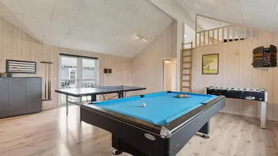 a room with a pool table and two tables at Villavilla 404 - Hostrup Strand, Limfjorden in Spottrup