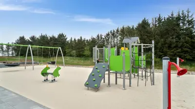 a playground with two children playing on a slide at Villavilla 431 - Hostrup Strand, Limfjorden in Spottrup