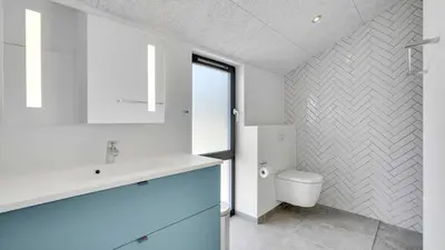 a bathroom with a white sink and a toilet at Villavilla 909 - Blokhus, Nordjylland in Blokhus