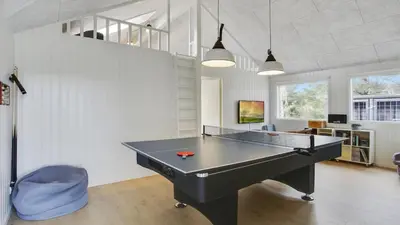 a ping pong table in a living room with at Villavilla 411 - Blokhus, Nordjylland in Blokhus