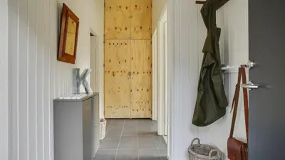 a hallway of a home with a door and a hallway at Villavilla 411 - Blokhus, Nordjylland in Blokhus