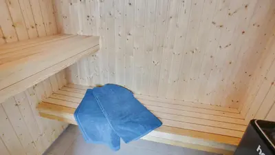a sauna with a blue towel sitting in it at Villavilla 411 - Blokhus, Nordjylland in Blokhus