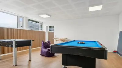 a room with a pool table and a table at Villavilla 645 - Hostrup Strand, Limfjorden in Spottrup