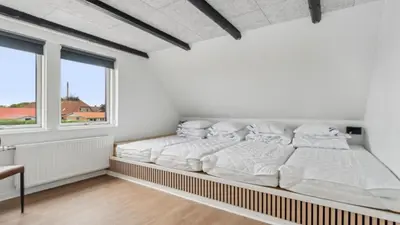 two beds in a white room with a window at Villavilla 645 - Hostrup Strand, Limfjorden in Spottrup