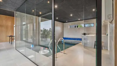 a glass shower in a bathroom with a swimming pool at Villavilla 684 - Virksund, Limfjorden in Højslev