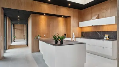 a kitchen with a white counter and wooden walls at Villavilla 684 - Virksund, Limfjorden in Højslev
