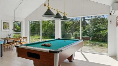 a pool table in a living room with a pool table at Villavilla 691 - Blokhus, Nordjylland in Blokhus