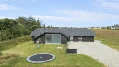 a small black house on a hill with a frisbee at Villavilla 637 - Vorupør, Nordjylland in Snedsted