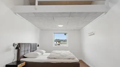 a bedroom with a bed and a window at Villavilla 680 - Blokhus, Nordjylland in Blokhus