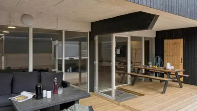 a living room with a couch and a table at Villavilla 680 - Blokhus, Nordjylland in Blokhus