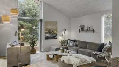 a living room with a couch and a table at Villavilla 683 - Blokhus, Nordjylland in Saltum