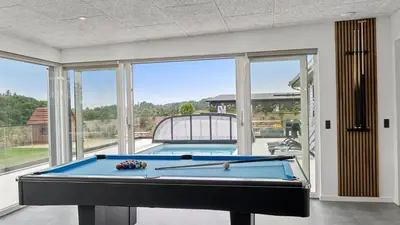 a pool table in a room with a large window at Villavilla 686 - Hostrup Strand, Limfjorden in Spottrup
