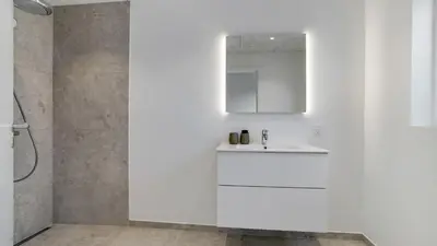 a white bathroom with a sink and a mirror at Villavilla 692 - Blokhus, Nordjylland in Blokhus