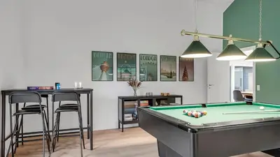a room with a pool table and a bar with stools at Villavilla 692 - Blokhus, Nordjylland in Blokhus