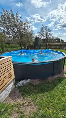 a group of people swimming in a hot tub at Peaceful Holiday Home With Pool Summer And Spa in Farsø