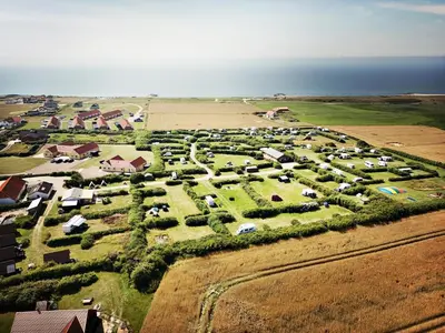an aerial view of a farm with cars parked at Bovbjerg Camping in Lemvig