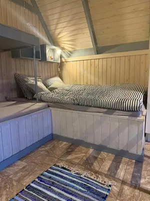 two beds sitting on a platform in a room at Bovbjerg Camping in Lemvig