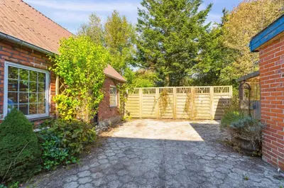 a brick house with a fence and a driveway at Villa With Three Bedrooms in Vemb