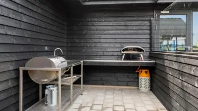 a outdoor kitchen with a sink and a grill at Villavilla 546 - Hostrup Strand, Limfjorden in Spottrup