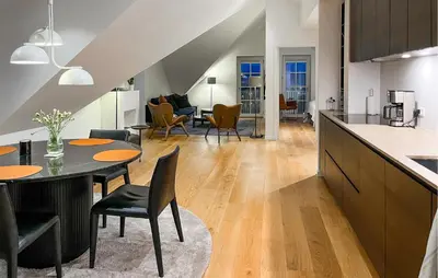 a kitchen and living room with a table and chairs at Amazing Apartment In Blokhus With House A Panoramic View in Blokhus