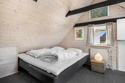 a bedroom with a bed in a wooden wall at 730-Thyboron-Manovej-9 in Thyborøn