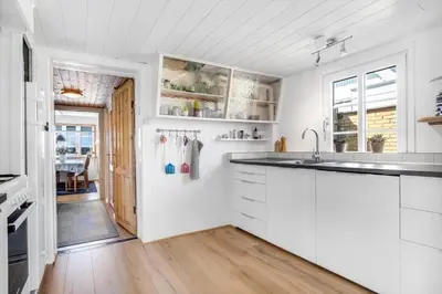 a kitchen with white cabinets and a sink at 730-Thyboron-Manovej-9 in Thyborøn