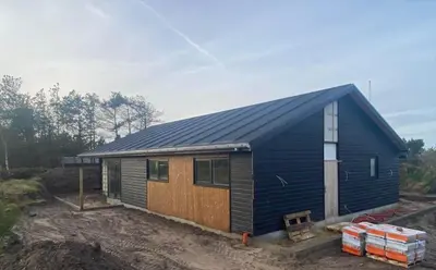 a blue shed with a metal roof at BL1149-Blokhus-Paa-Bakken-12 in Blokhus