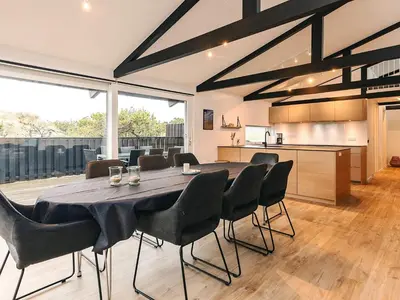 a large dining room with a table and chairs at 5 star holiday home in Saltum in Saltum