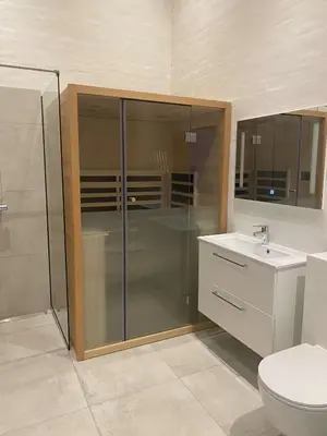a bathroom with a shower and a toilet and a sink at Luxury cottage close to the beach in Løkken